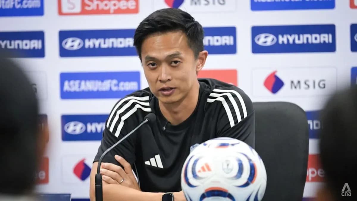 Manager speaking at press conference with football Manager speaking at press conference with football