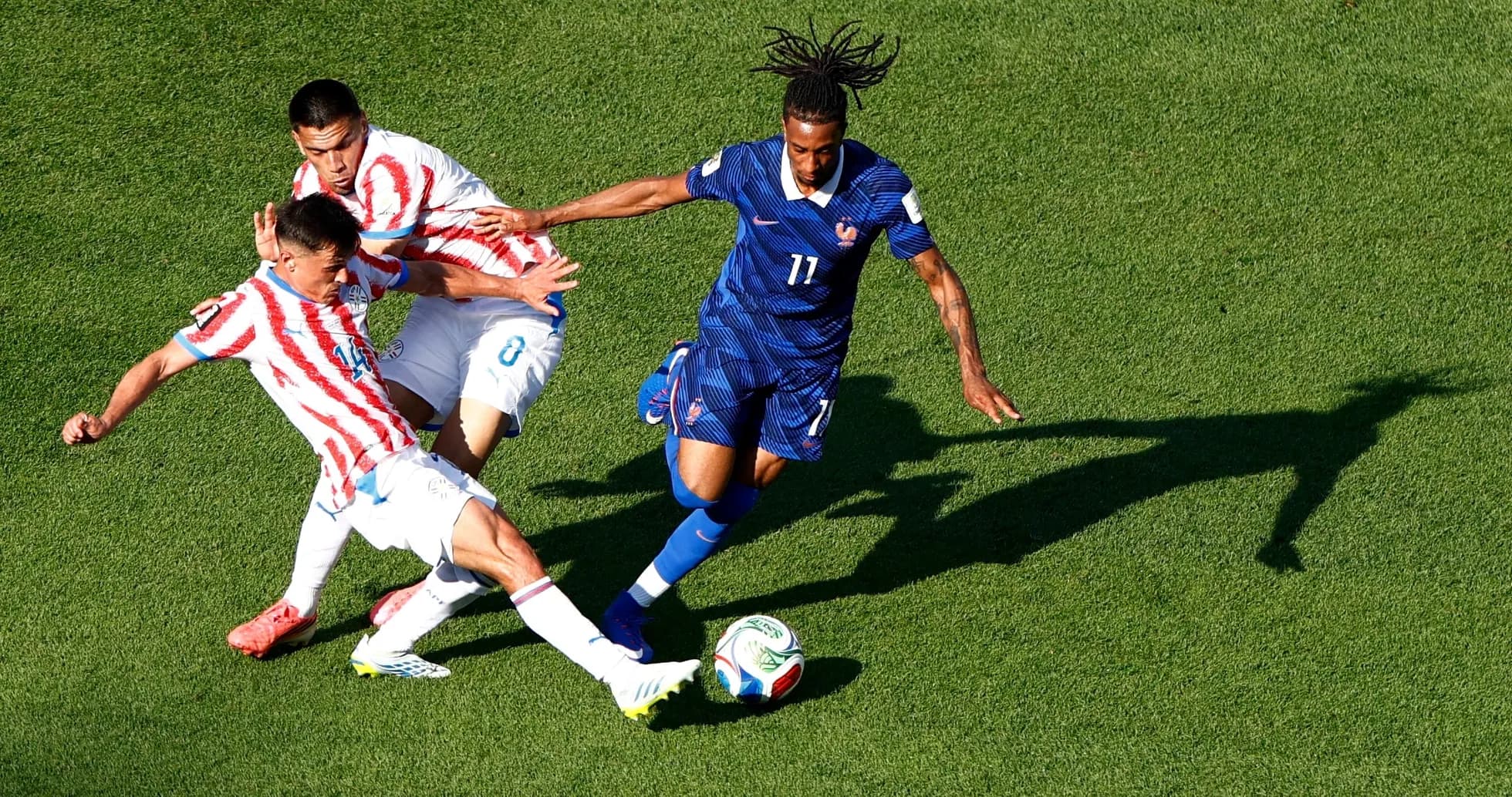 Paraguay and France players competing for the ball Paraguay and France players competing for the ball