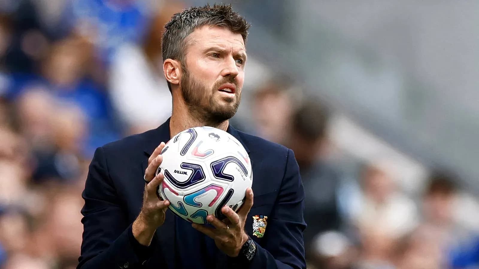 Coach holding a soccer ball during match Coach holding a soccer ball during match