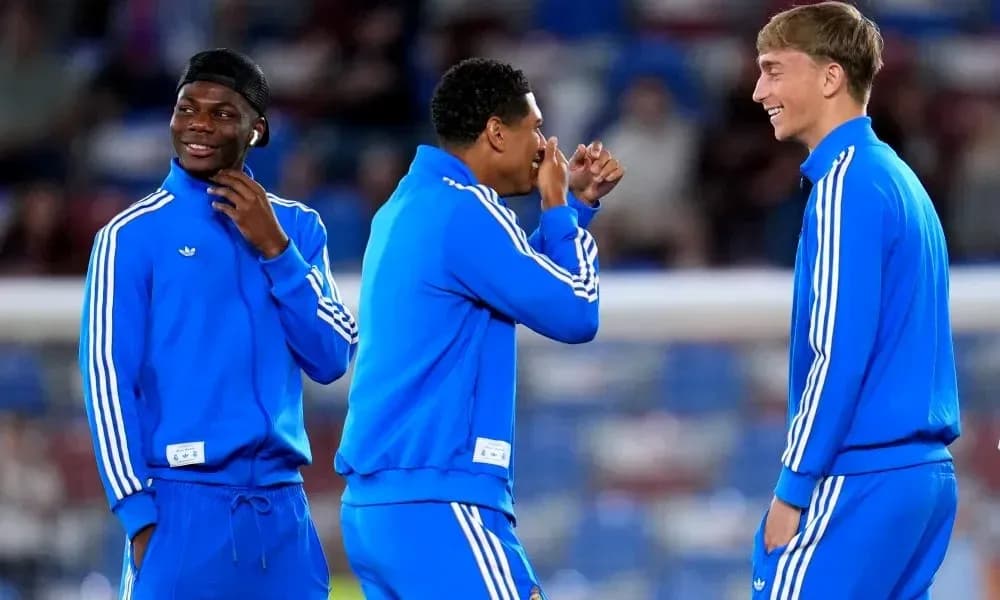 Three players laughing and chatting in training gear Three players laughing and chatting in training gear