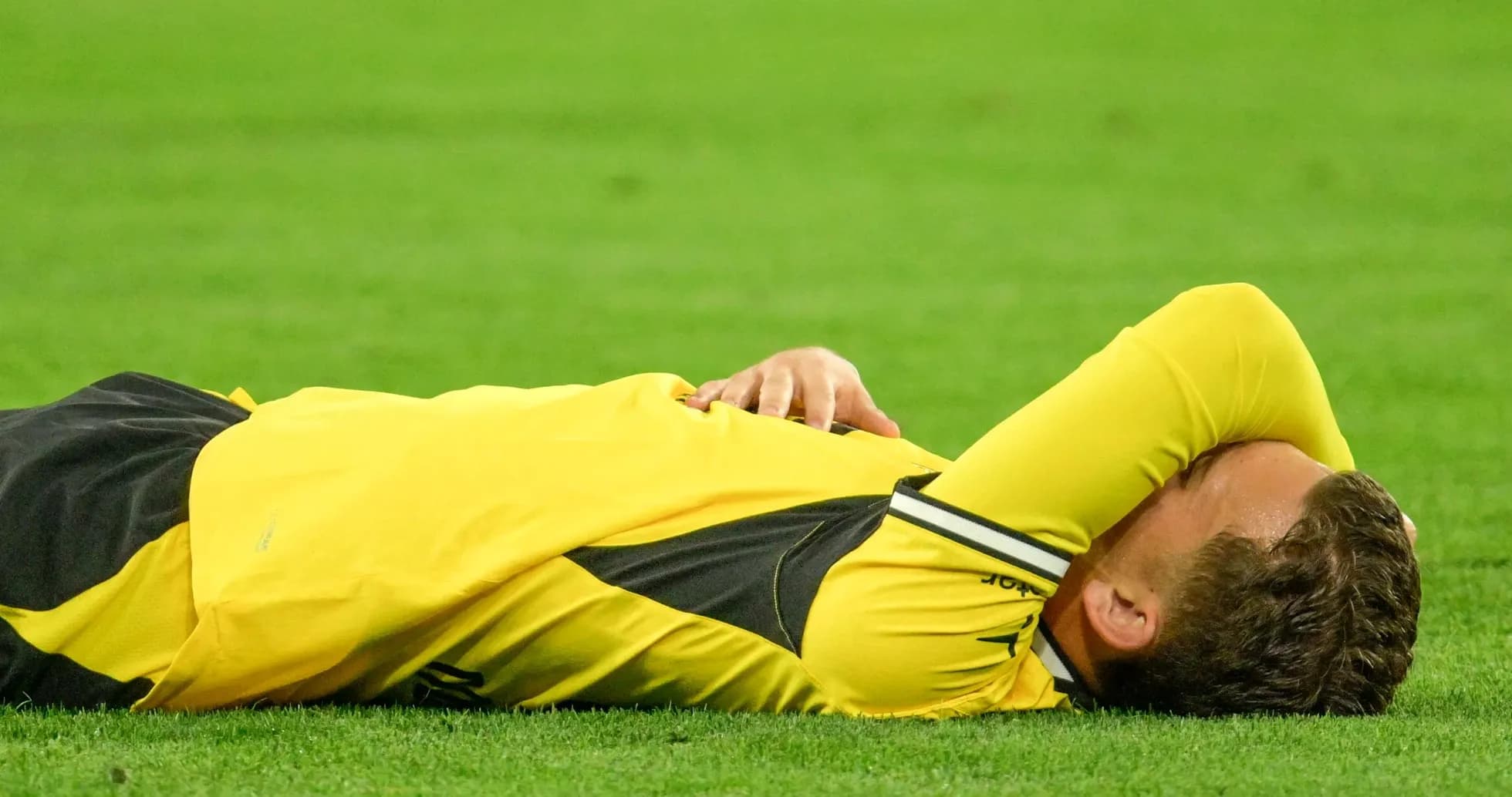 Player lying on the field after a fall Player lying on the field after a fall