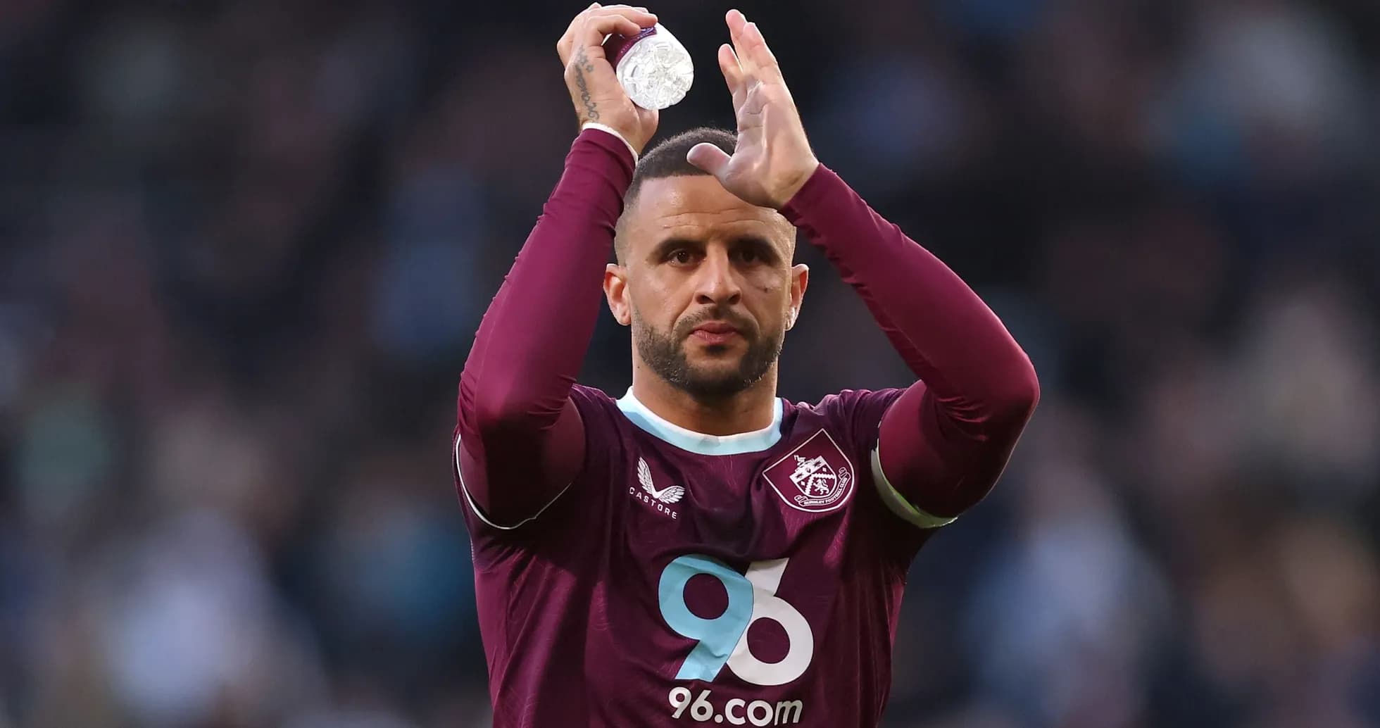 Player applauding the crowd while holding a bottle Player applauding the crowd while holding a bottle