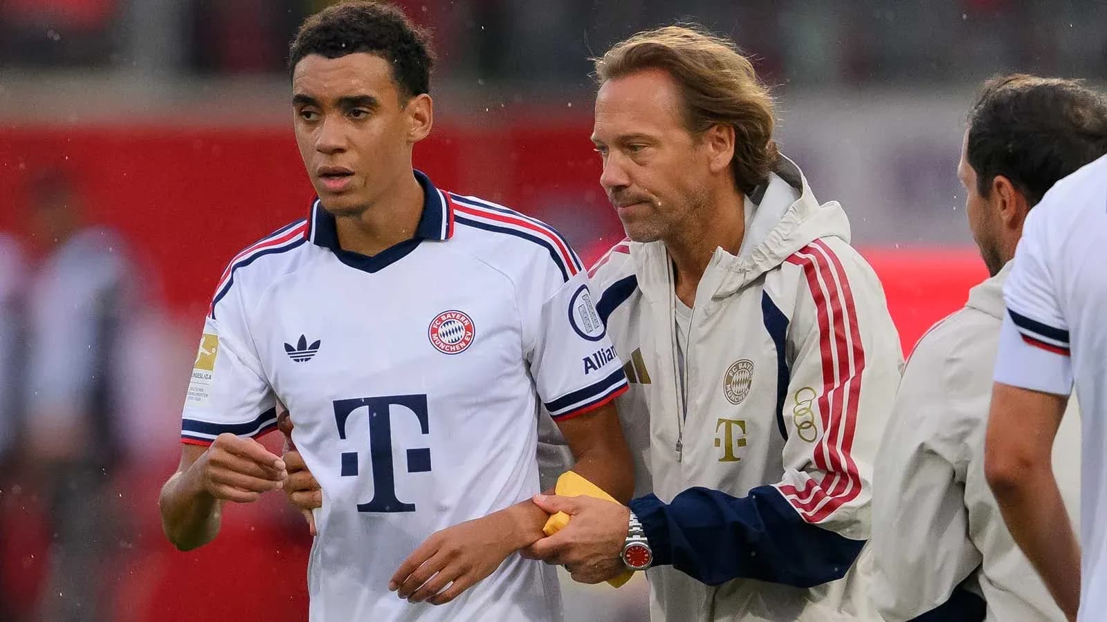 Bayern Munich player receiving instructions from coach Bayern Munich player receiving instructions from coach