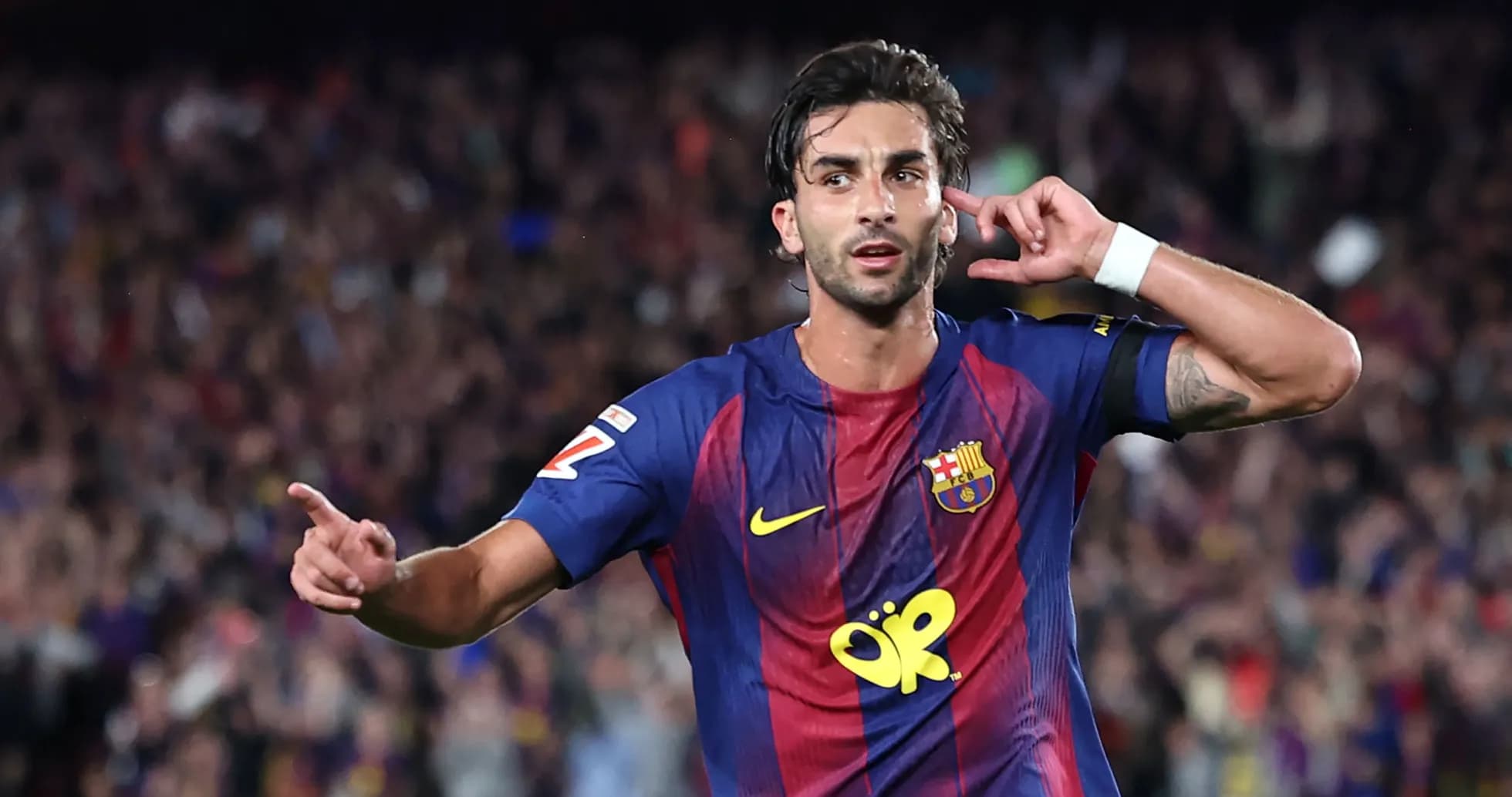 Barcelona player celebrating goal with crowd in background Barcelona player celebrating goal with crowd in background