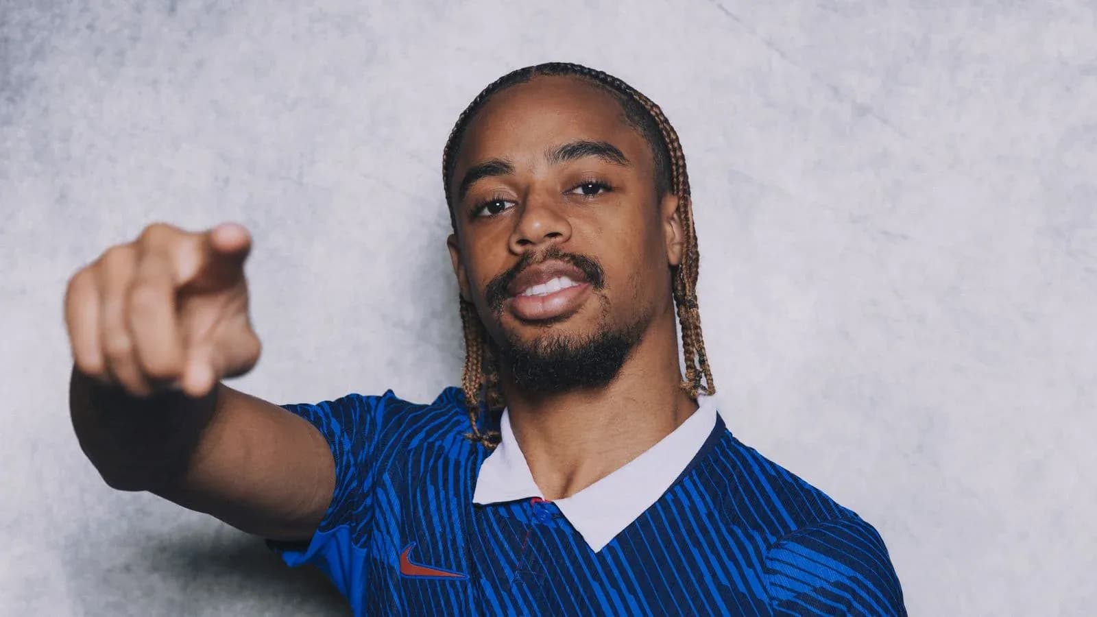 Player pointing while wearing blue jersey Player pointing while wearing blue jersey