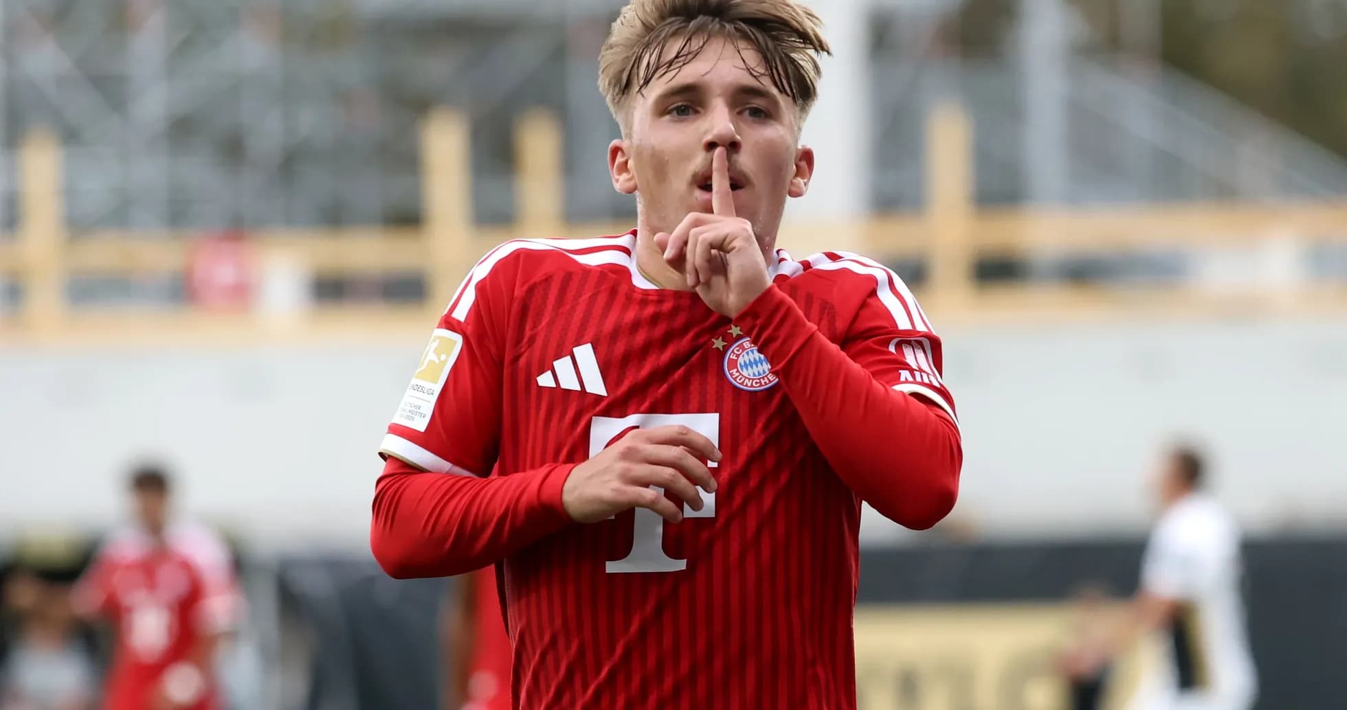 Player celebrating goal with a shushing gesture Player celebrating goal with a shushing gesture