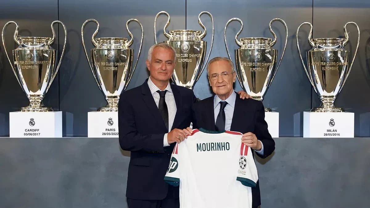 Jose Mourinho holding a jersey with Florentino Perez Jose Mourinho holding a jersey with Florentino Perez
