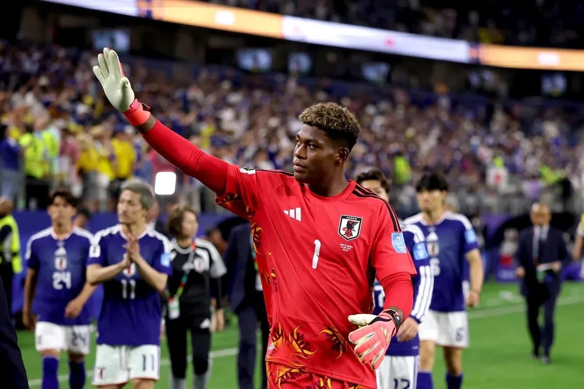 Goalkeeper in red jersey waving to the crowd Goalkeeper in red jersey waving to the crowd