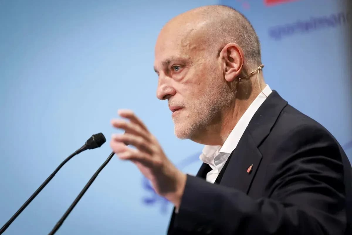 Speaker gesturing during a press conference presentation Speaker gesturing during a press conference presentation
