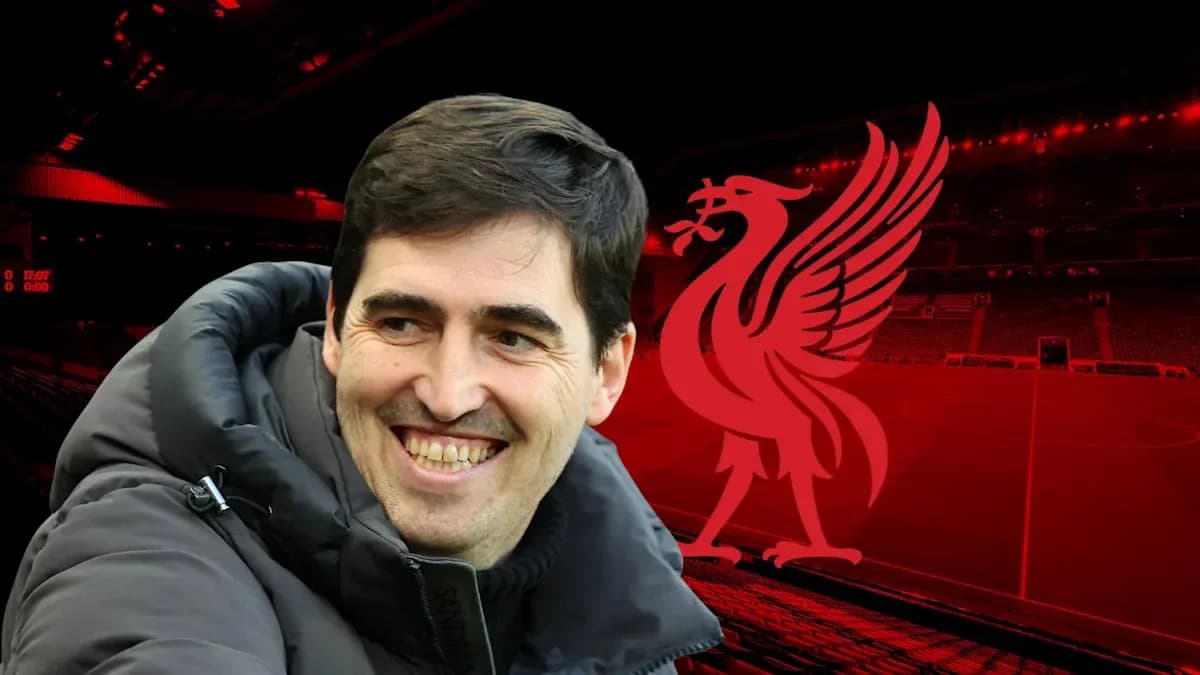 Smiling coach with Liverpool logo in background Smiling coach with Liverpool logo in background