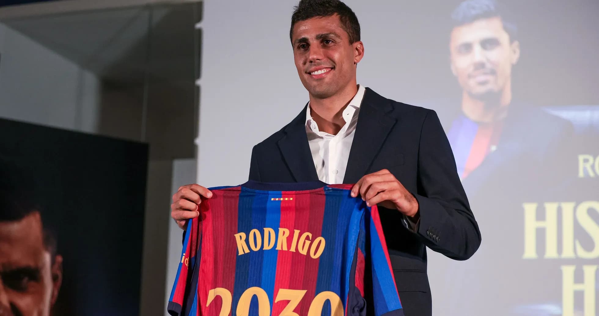 Player holding Barcelona jersey with name Rodrigo Player holding Barcelona jersey with name Rodrigo