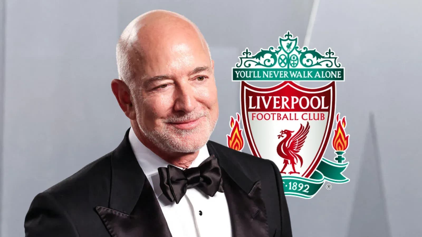 Man in tuxedo with Liverpool FC logo in background Man in tuxedo with Liverpool FC logo in background
