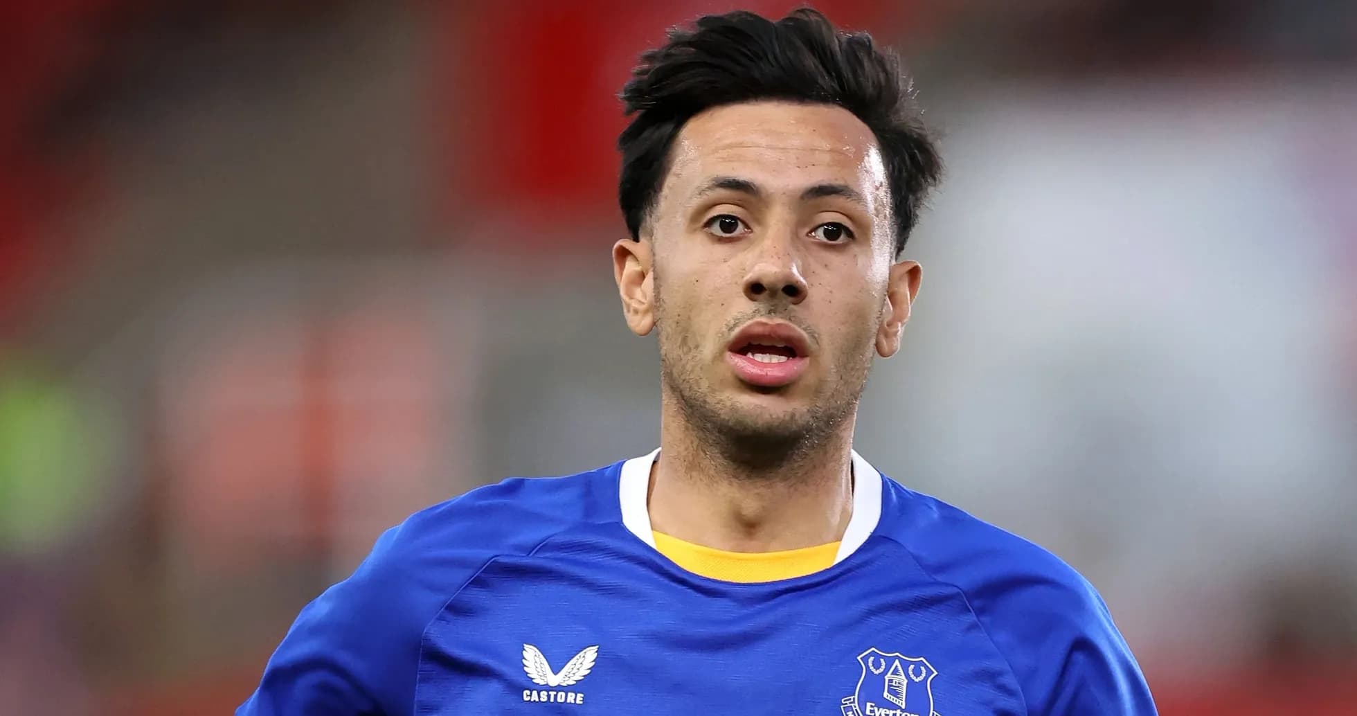 Player in Everton jersey running on the pitch Player in Everton jersey running on the pitch