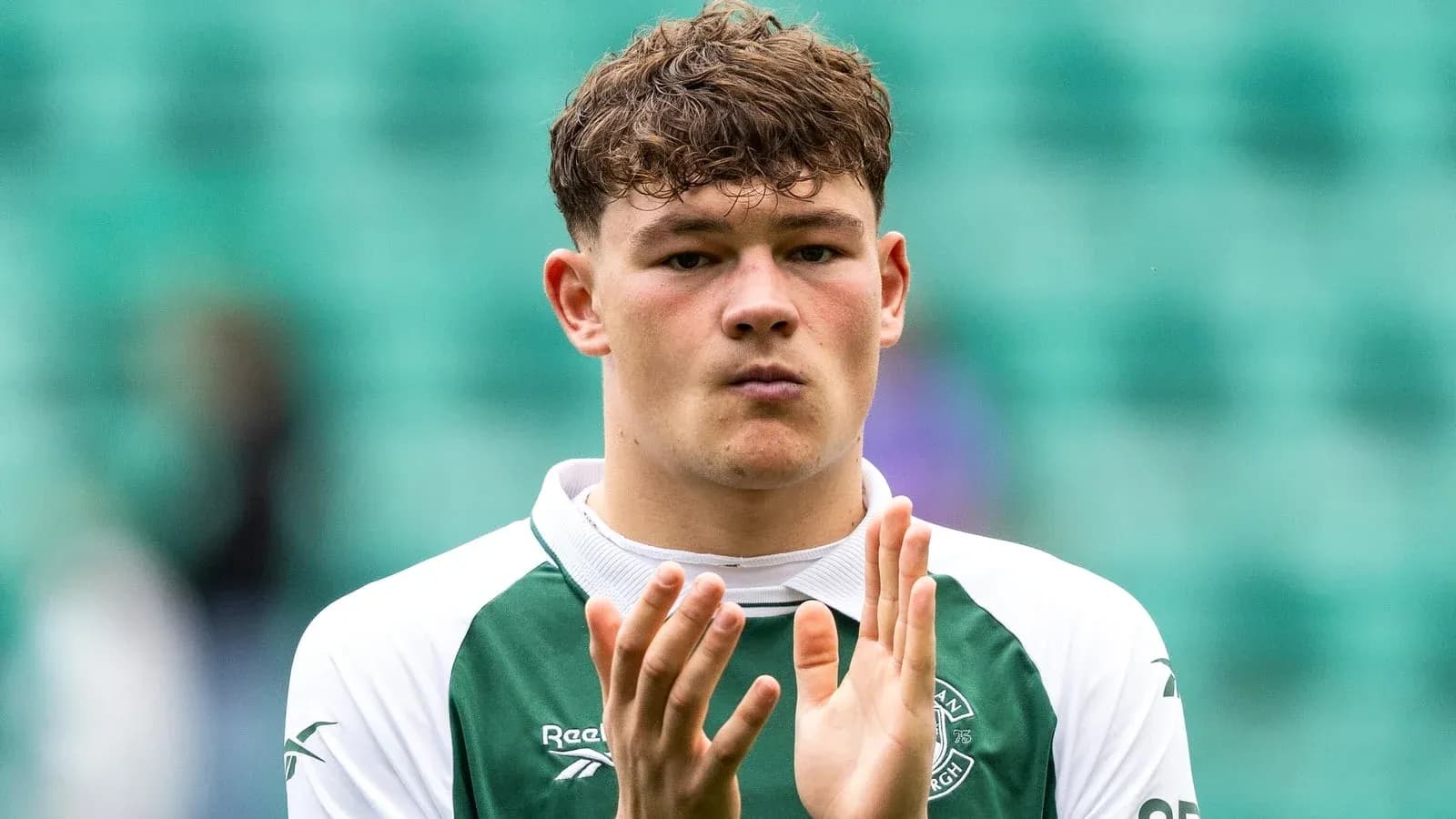 Player applauding in Hibernian team jersey Player applauding in Hibernian team jersey