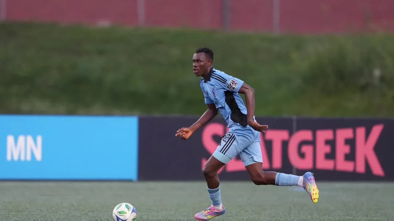Player in blue jersey running with the ball Player in blue jersey running with the ball