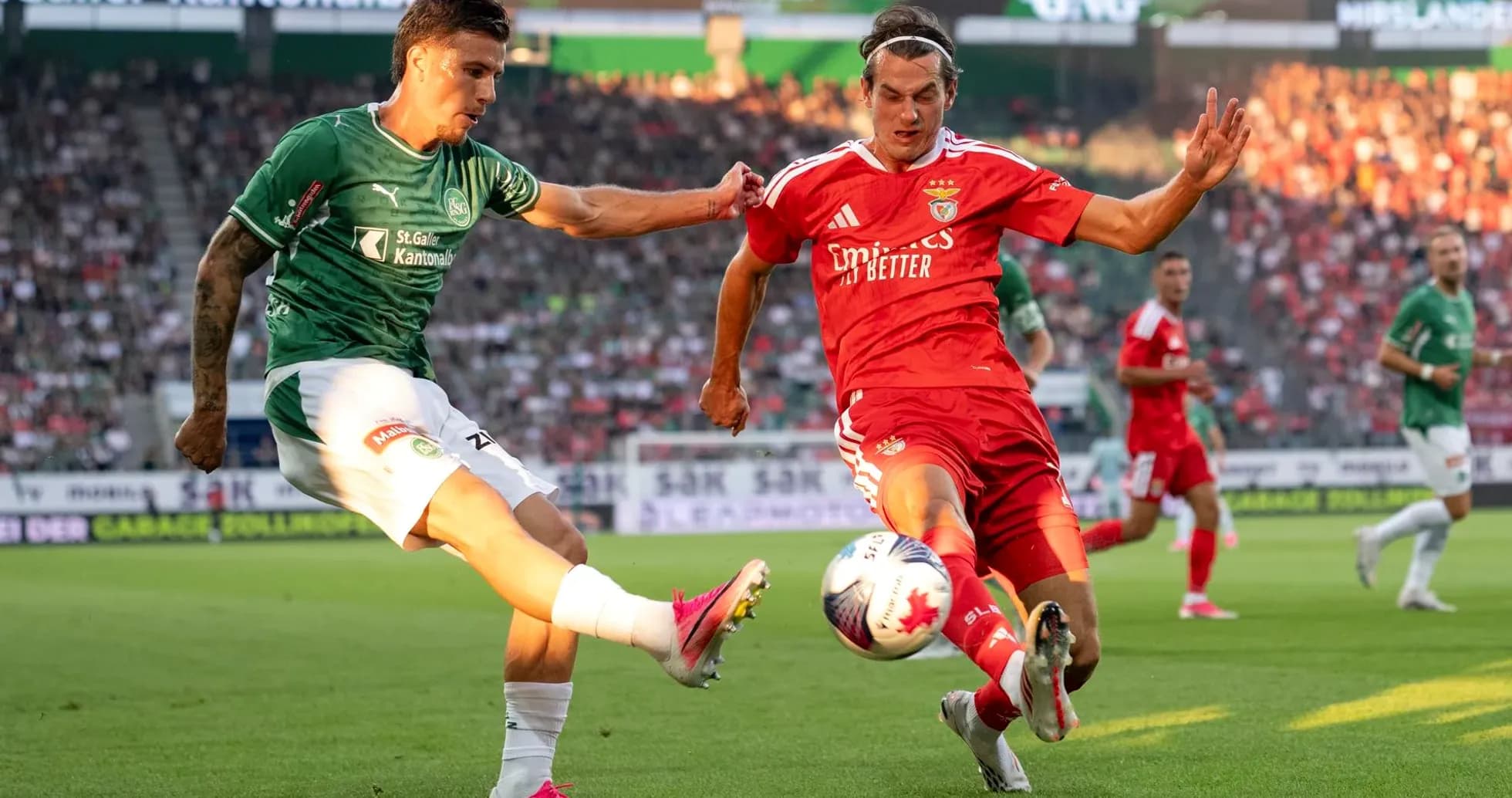 Benfica player tackling FC St. Gallen opponent Benfica player tackling FC St. Gallen opponent