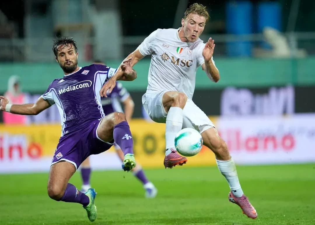 Fiorentina player challenging Napoli player for ball Fiorentina player challenging Napoli player for ball