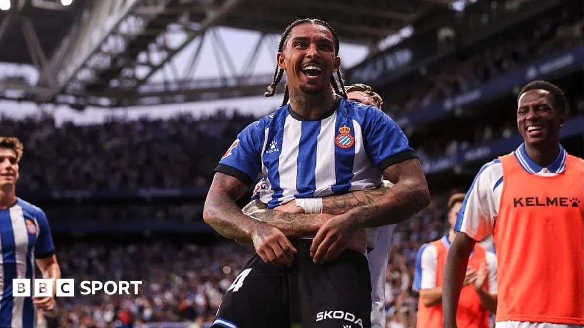 Espanyol player celebrating with teammates after scoring Espanyol player celebrating with teammates after scoring