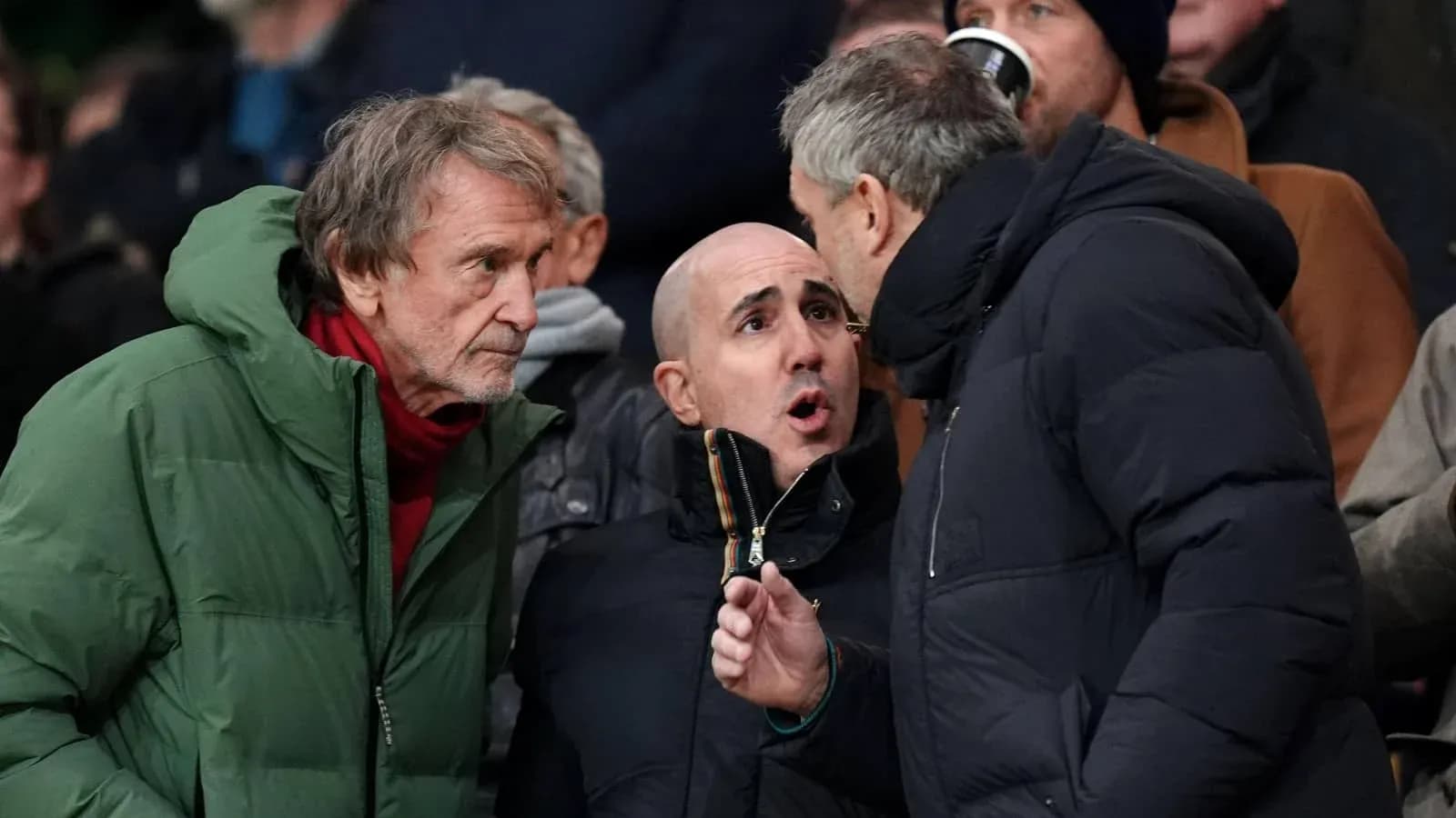 Three spectators discussing during a sporting event Three spectators discussing during a sporting event