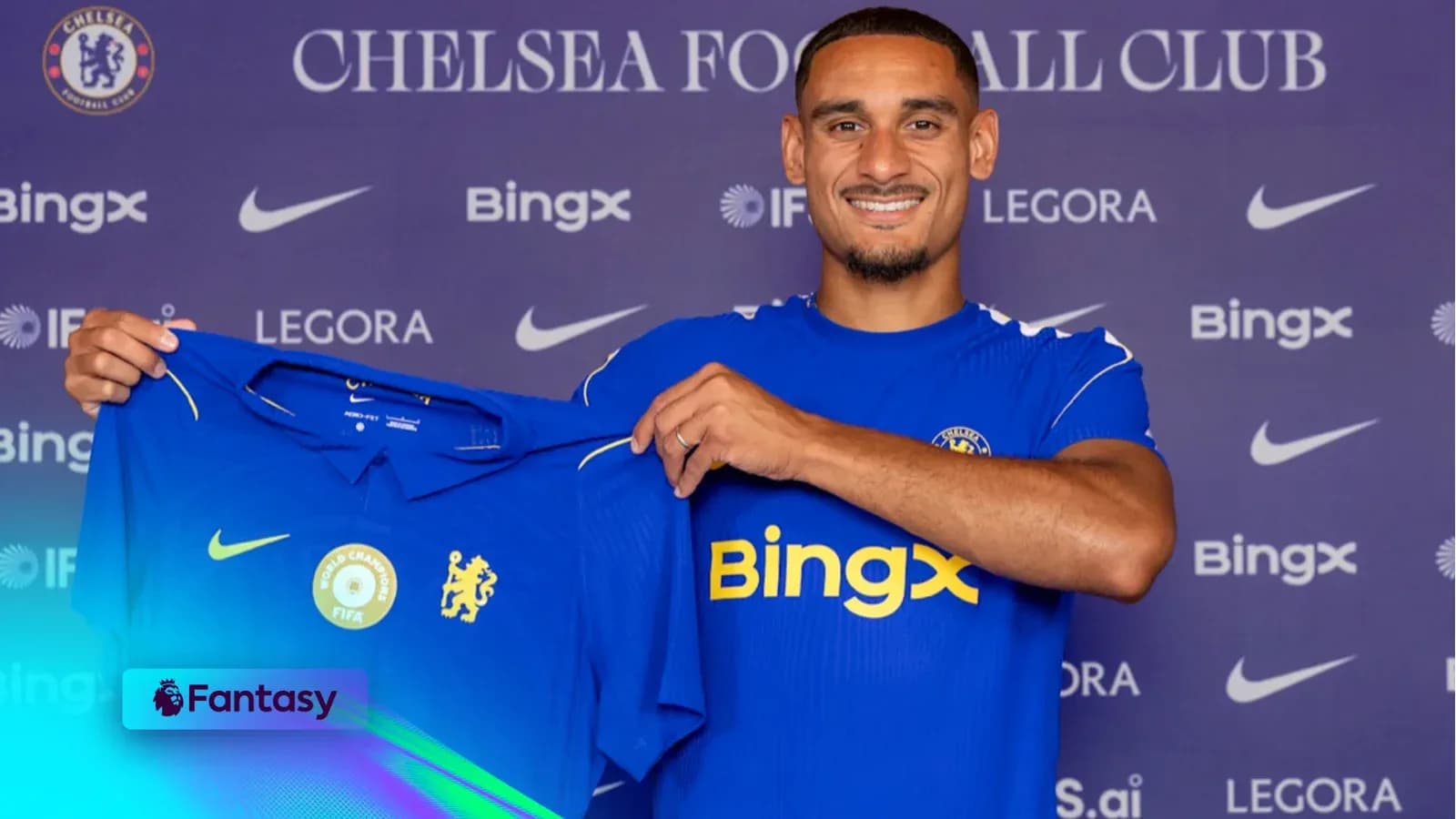 Player holding Chelsea jersey at press conference Player holding Chelsea jersey at press conference