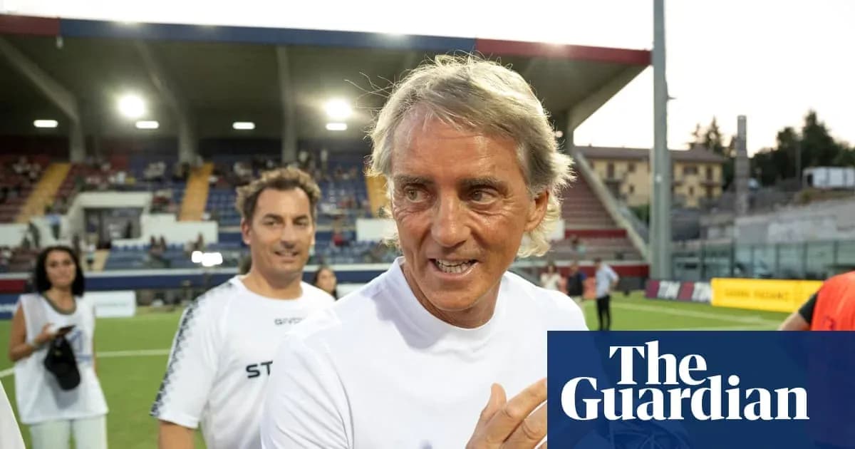 Coach smiling on the pitch after a match Coach smiling on the pitch after a match