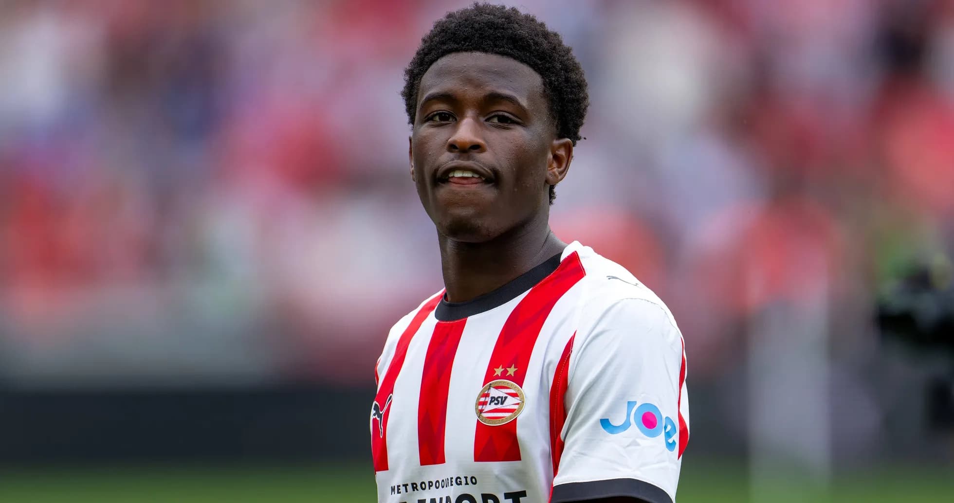 Player in PSV Eindhoven jersey on the field Player in PSV Eindhoven jersey on the field