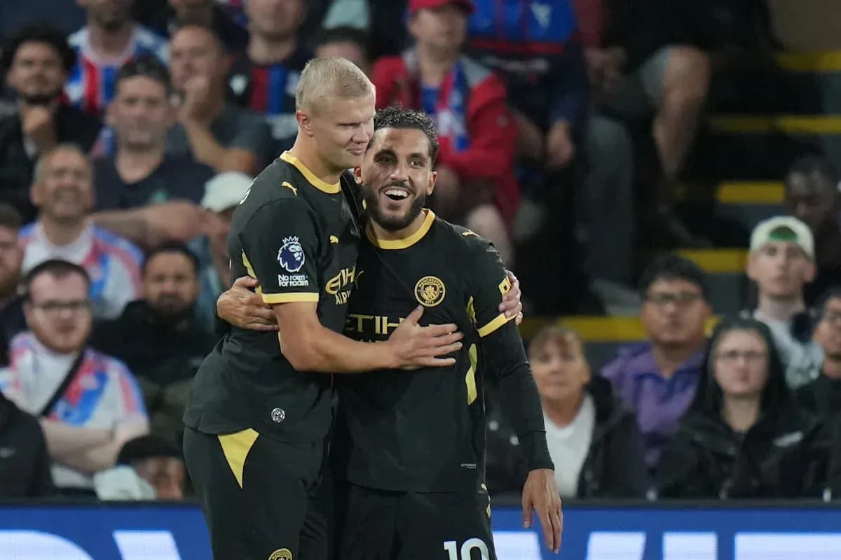 Two Manchester City players celebrating a goal together Two Manchester City players celebrating a goal together