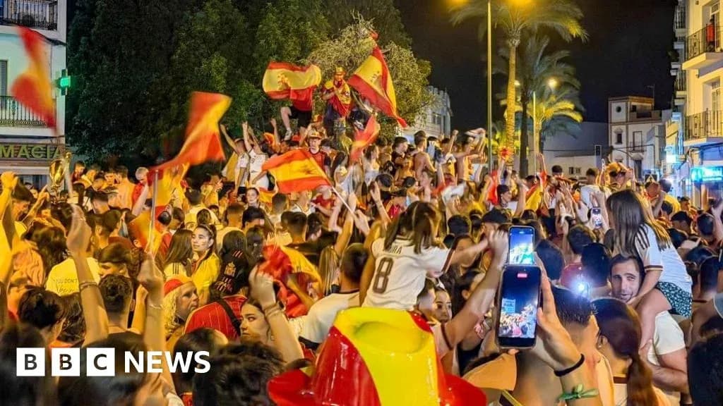 Crowd celebrating with Spanish flags at night Crowd celebrating with Spanish flags at night
