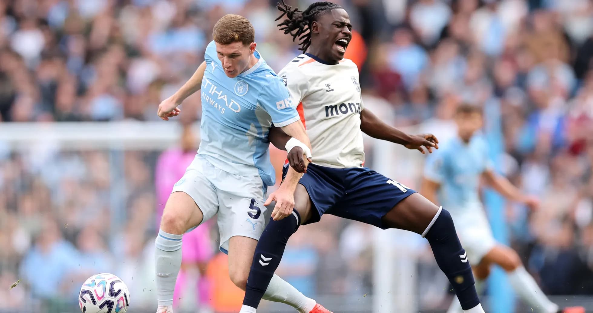 Manchester City player tackling Coventry opponent Manchester City player tackling Coventry opponent