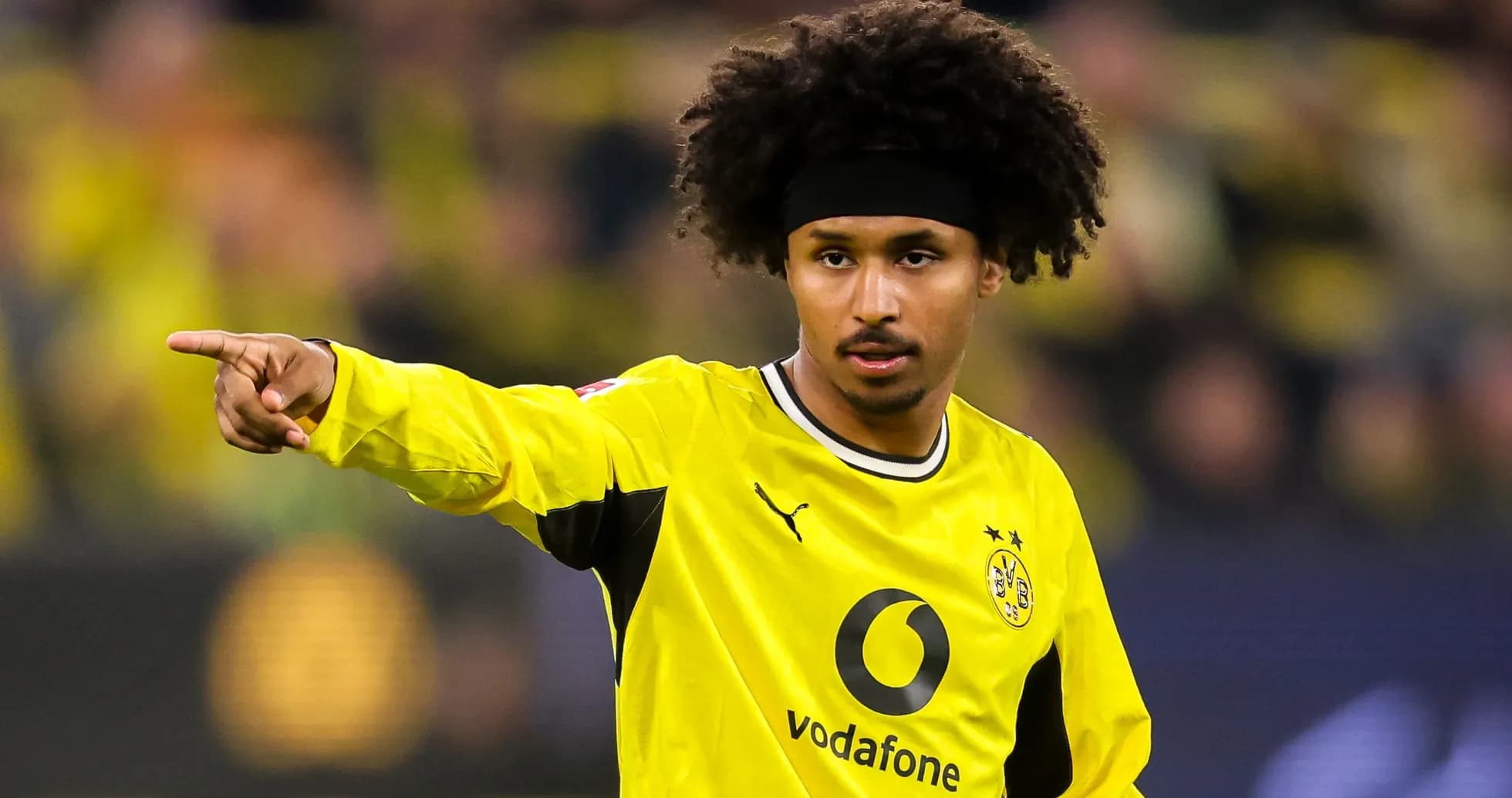 Player pointing during match in yellow jersey Player pointing during match in yellow jersey