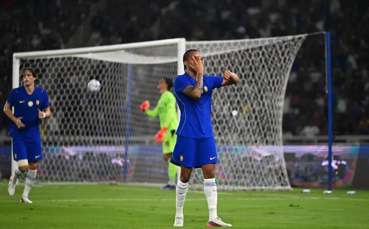Player reacting during football match with goal in background Player reacting during football match with goal in background