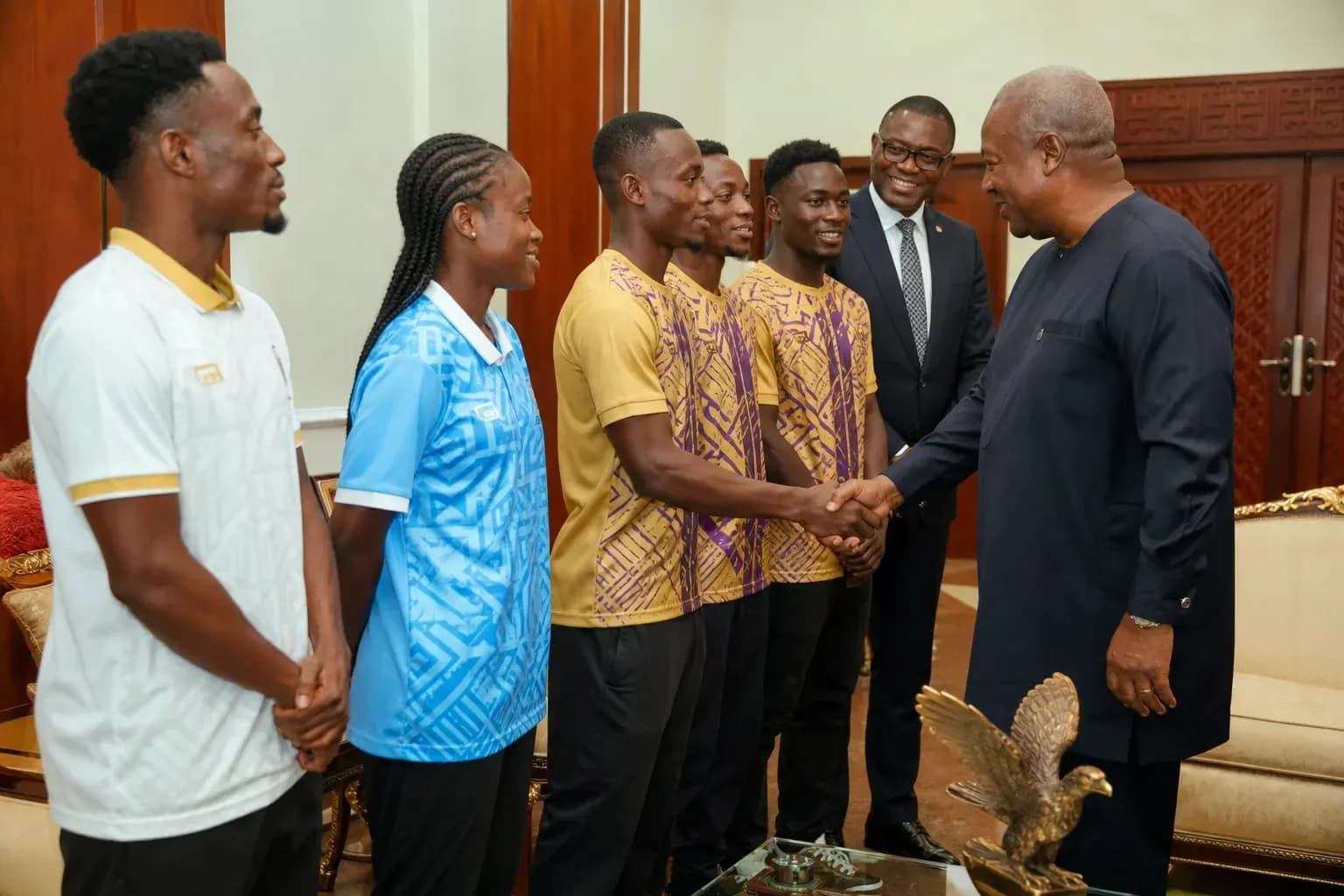 Athletes meeting official, shaking hands in office Athletes meeting official, shaking hands in office