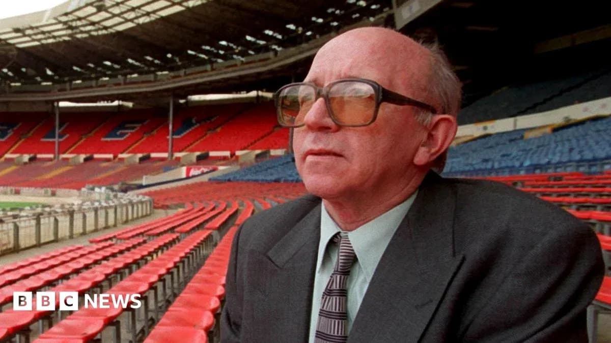 Person seated in empty stadium with red seats Person seated in empty stadium with red seats