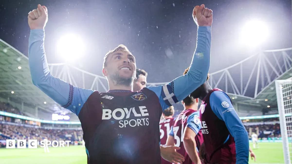 Player celebrating a goal with raised arms Player celebrating a goal with raised arms