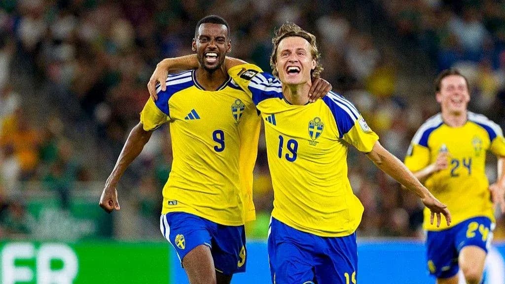 Two Swedish players celebrating a goal on the field Two Swedish players celebrating a goal on the field