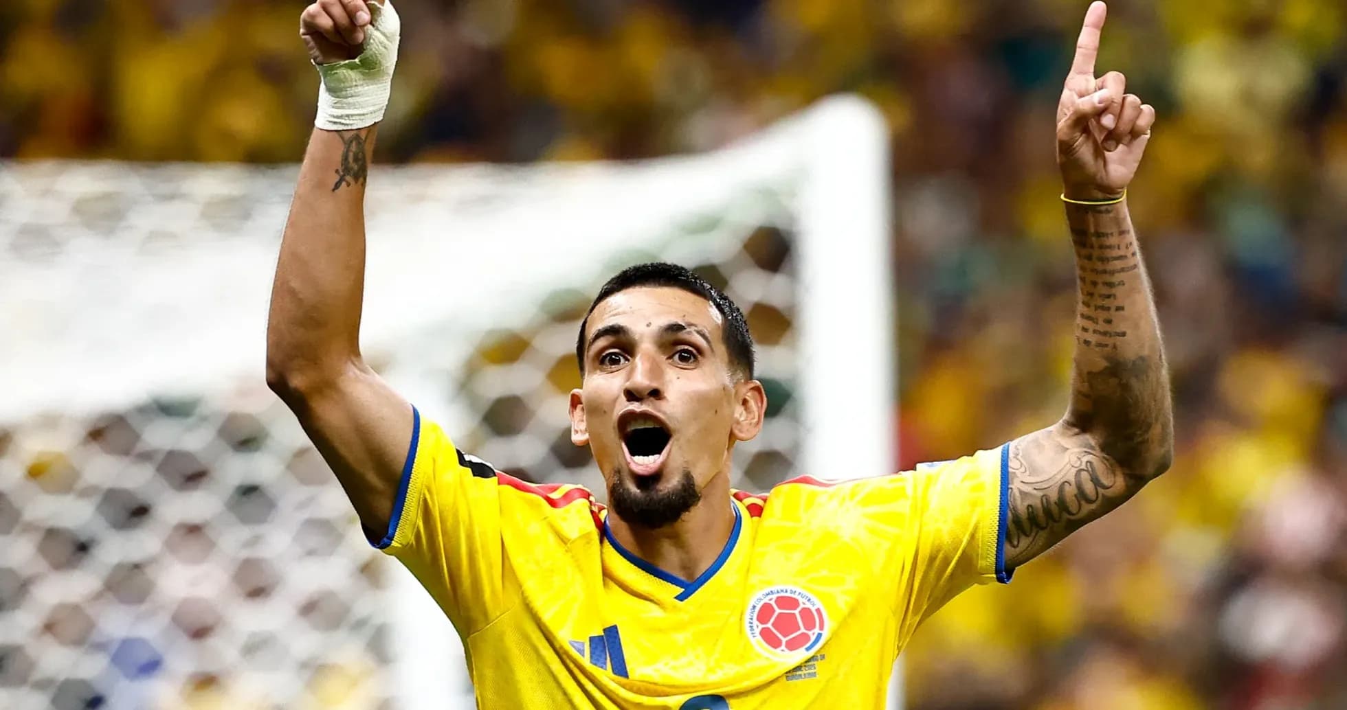 Player celebrating a goal in yellow jersey Player celebrating a goal in yellow jersey