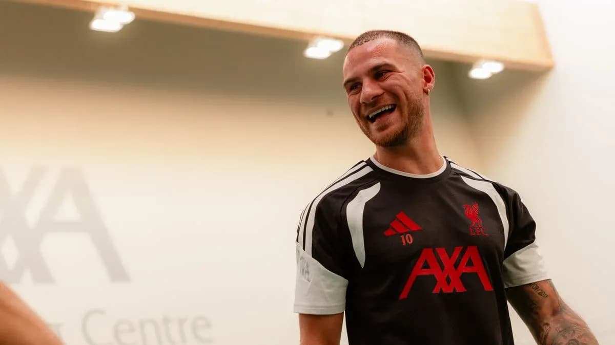 Player in Liverpool training kit smiling indoors Player in Liverpool training kit smiling indoors