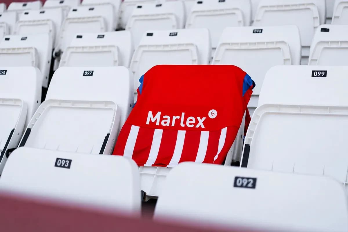 Red and white jersey on empty stadium seat Red and white jersey on empty stadium seat