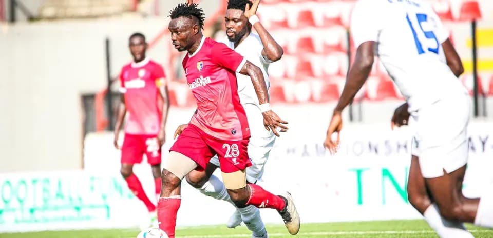 Katsina United player dribbling past Rivers United opponent Katsina United player dribbling past Rivers United opponent