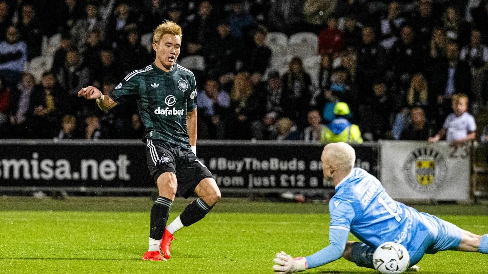 Player attempting to score while goalkeeper makes save Player attempting to score while goalkeeper makes save