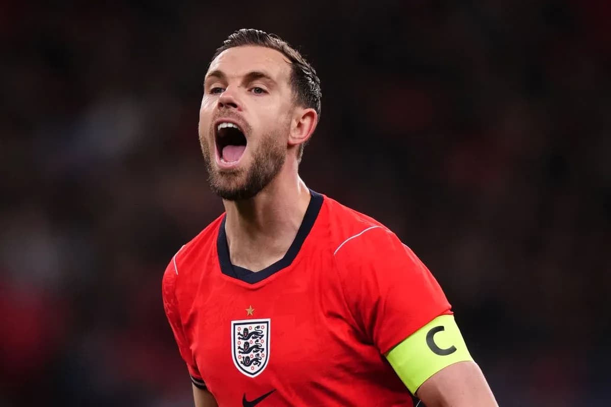 Player celebrating with arms raised in red jersey Player celebrating with arms raised in red jersey