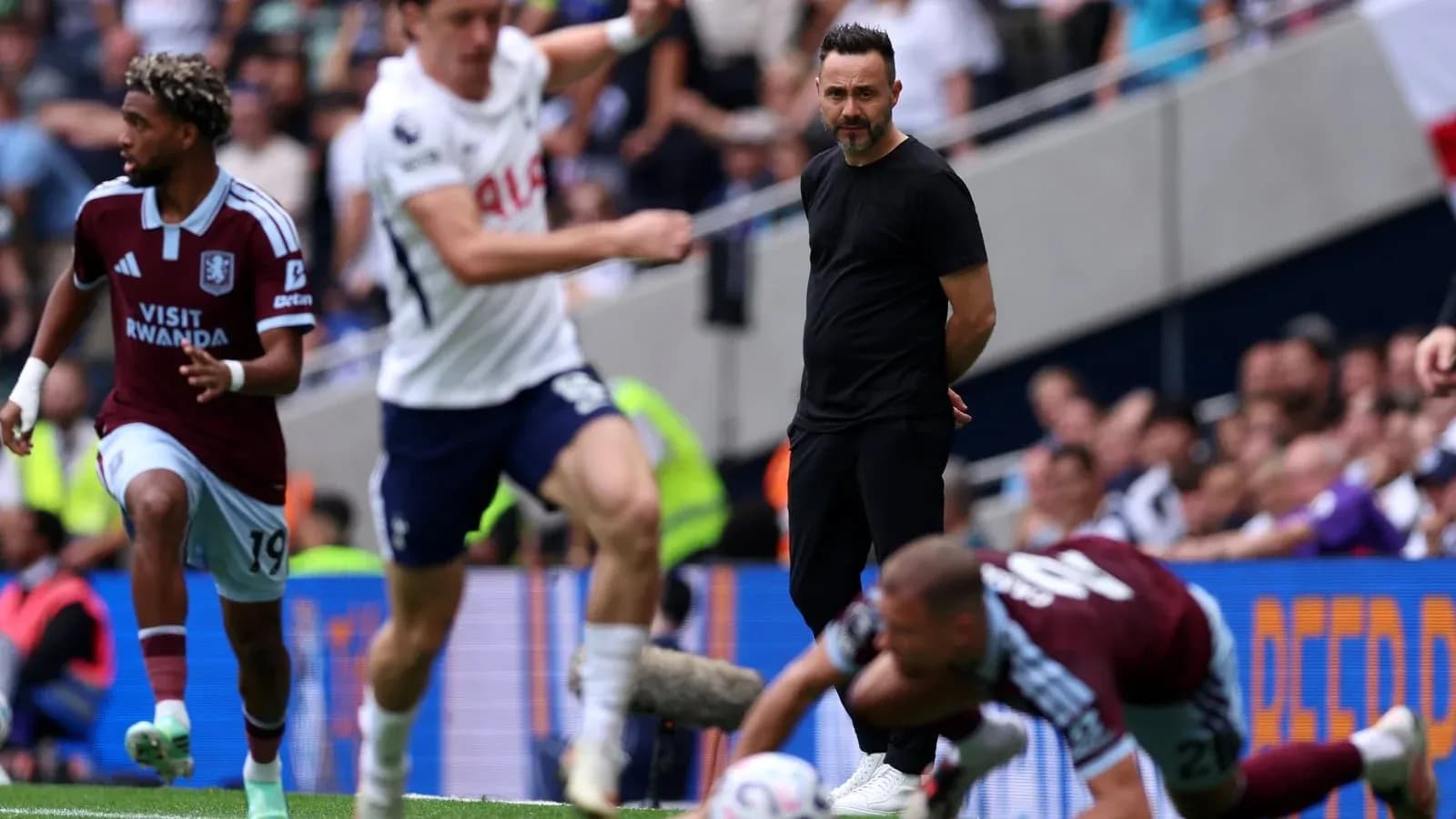 Aston Villa player running past Tottenham's coach Aston Villa player running past Tottenham's coach